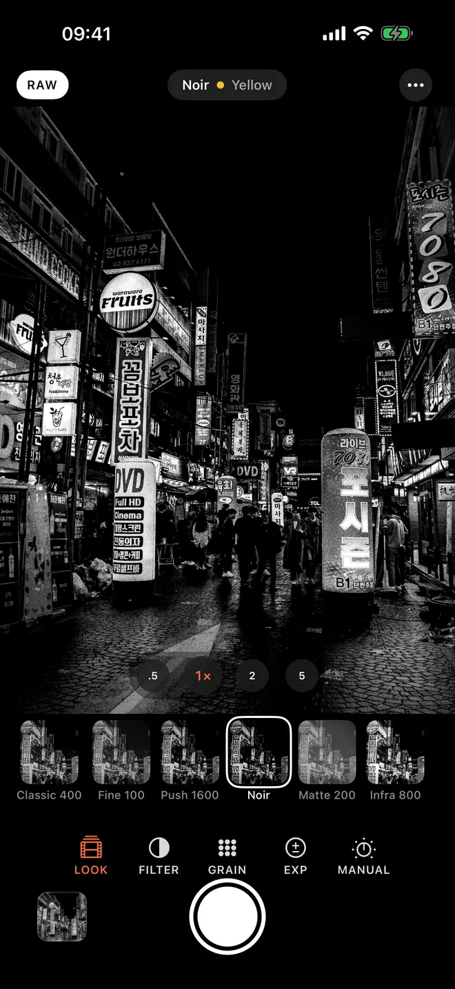 B&W Camera with the Looks tray open and Noir selected over a neon street