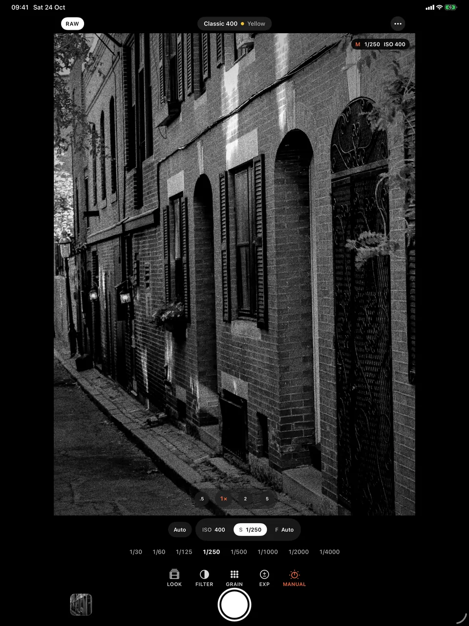 B&W Camera on iPad with manual shutter speeds shown under a brick alley